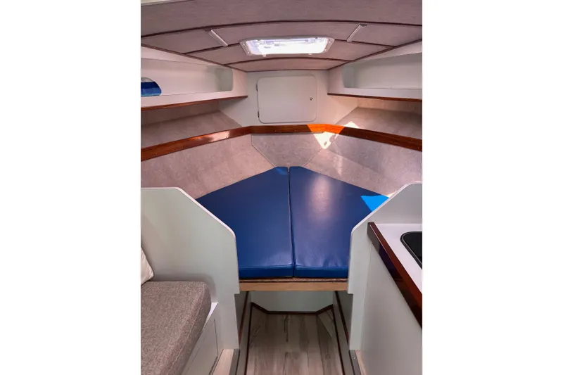 Slide: The Image of 1987 Chris Craft Amerosport cabin interior with blue cushions and wood accents. - 15