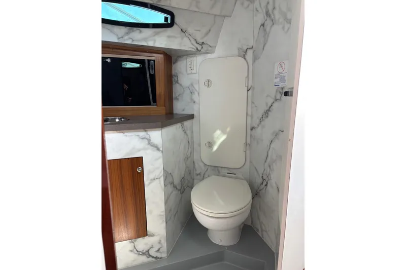 Slide: The Image of 1987 Chris Craft Amerosport bathroom with marble walls and wooden cabinetry. - 16