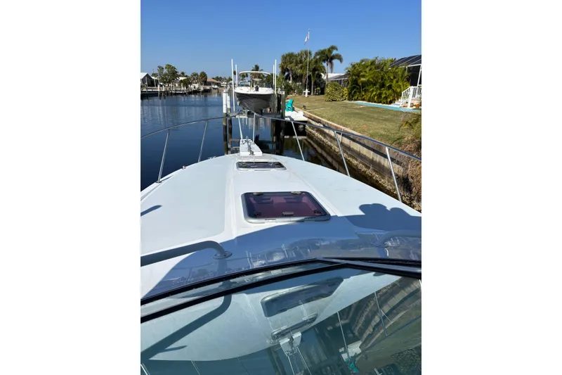 Slide: The Image of 1987 Chris Craft Amerosport boat docked in a sunny canal setting. - 5