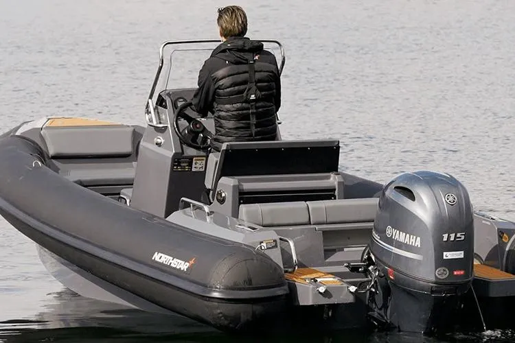 Slide: The Image of 2026 Northstar Orion 6 boat with Yamaha 115 engine on calm water. - 8
