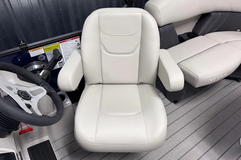 Slide: The Image of 2026 Sylvan Mirage 820 LZ boat interior with plush captain's chair and steering wheel. - 12