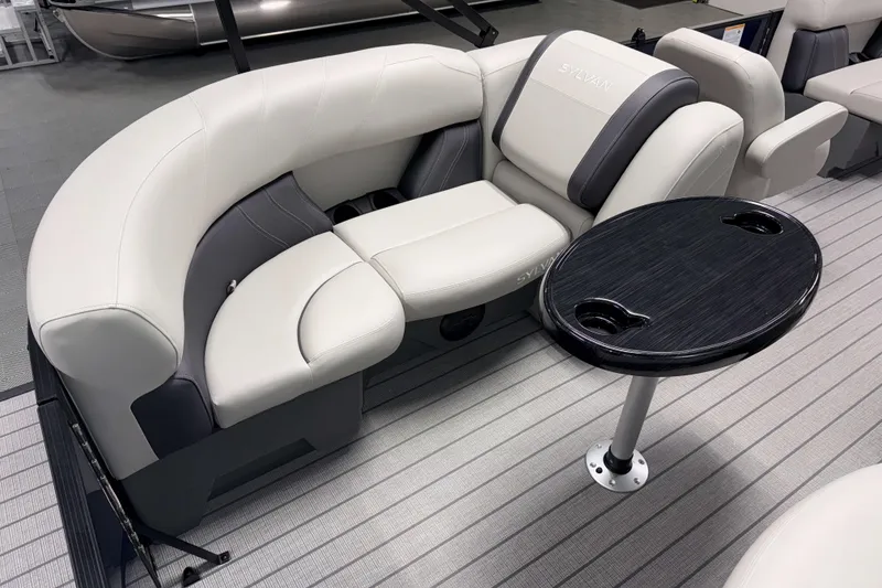 Slide: The Image of Luxurious seating area on 2026 Sylvan Mirage 820 LZ pontoon boat with sleek table design. - 14