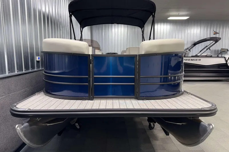 Slide: The Image of 2026 Sylvan Mirage 820 LZ pontoon boat in showroom, blue exterior, modern design. - 17