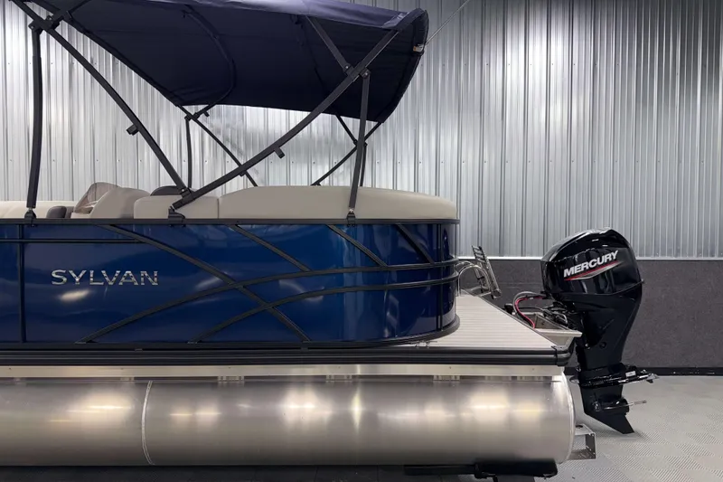 Slide: The Image of 2026 Sylvan Mirage 820 LZ pontoon boat with Mercury outboard motor in a showroom. - 20