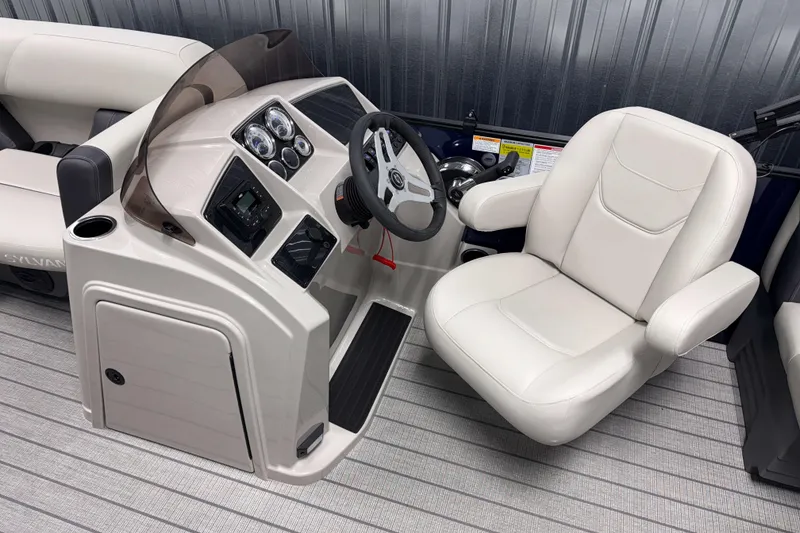 Slide: The Image of 2026 Sylvan Mirage 820 LZ boat interior with steering console and plush seating. - 7