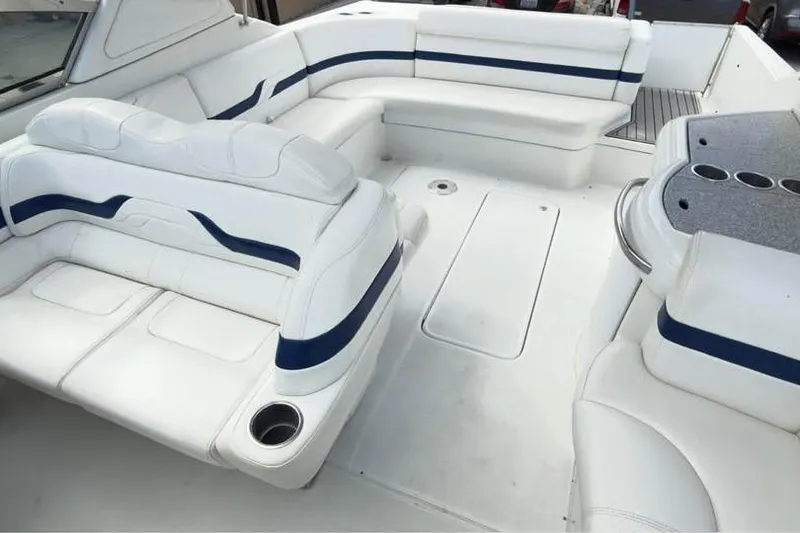 Slide: The Image of 2005 Formula 330 Sun Sport boat interior with white seating and blue accents. - 10