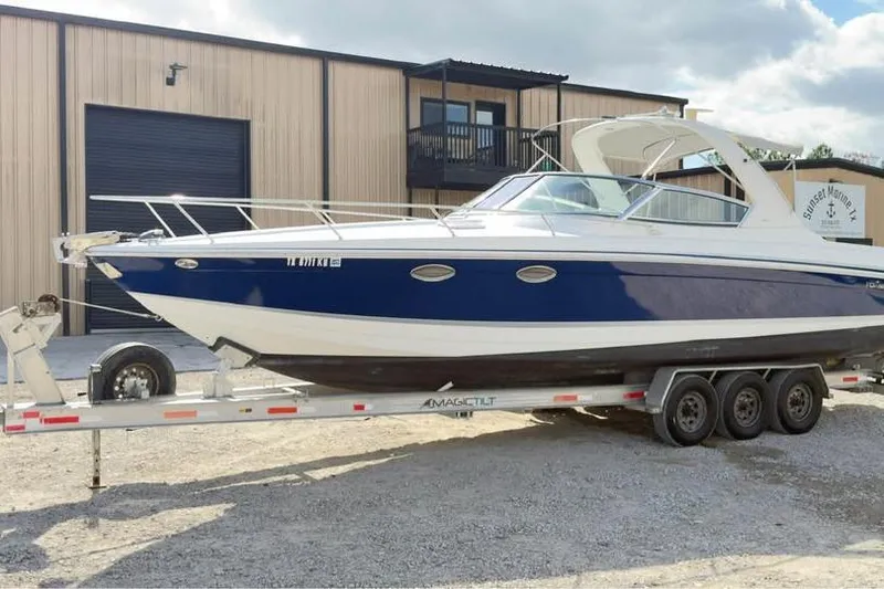 Slide: The Image of 2005 Formula 330 Sun Sport boat on trailer outside a warehouse. - 15