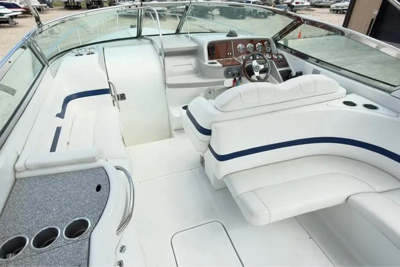 Slide: The Image of 2005 Formula 330 Sun Sport boat interior with white seating and control panel. - 5