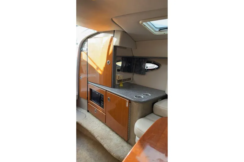Slide: The Image of Interior of 2005 Formula 330 Sun Sport boat with kitchenette and seating area. - 6
