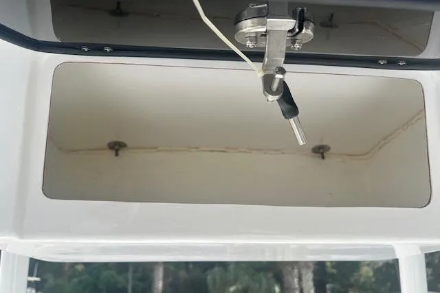 Slide: The Image of Open storage compartment in 2024 Savannah SS21 boat, featuring secure latch mechanism. - 10