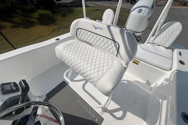 Slide: The Image of 2024 Savannah SS21 boat interior with white quilted seating and steering console. - 11