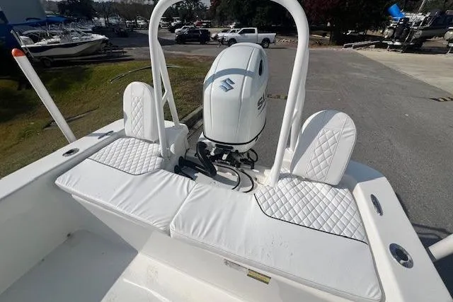 Slide: The Image of 2024 Savannah SS21 boat with white cushioned seating and Suzuki outboard motor. - 12