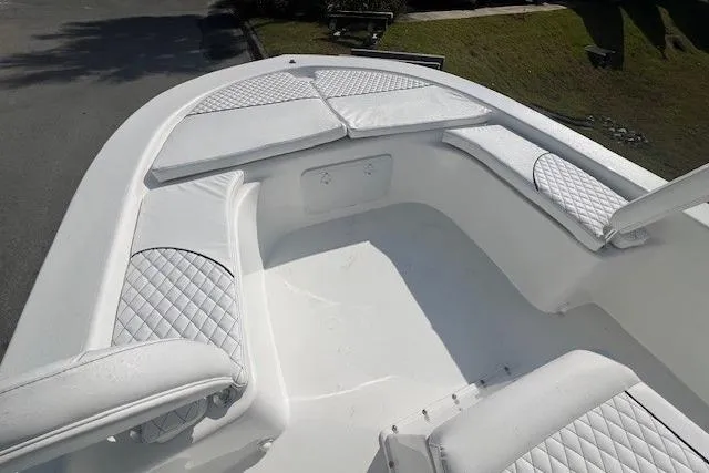 Slide: The Image of 2024 Savannah SS21 boat interior with white cushioned seating and quilted design. - 13