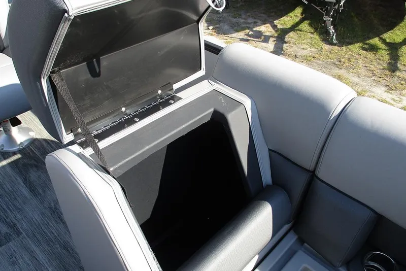 Slide: The Image of 2026 Bentley Pontoons Legacy 220 Swingback storage compartment with open lid, showcasing interior space. - 15