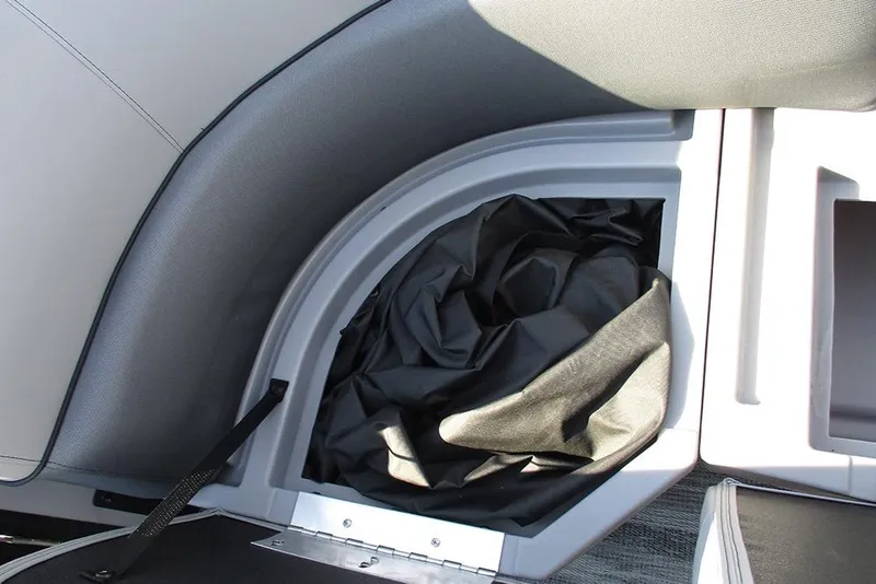 Slide: The Image of 2026 Bentley Pontoons Legacy 220 Swingback storage compartment with black cover. - 19