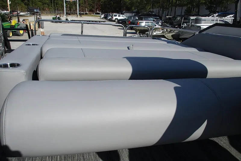 Slide: The Image of 2026 Bentley Pontoons Legacy 220 Swingback with sleek gray seating and cup holders. - 23