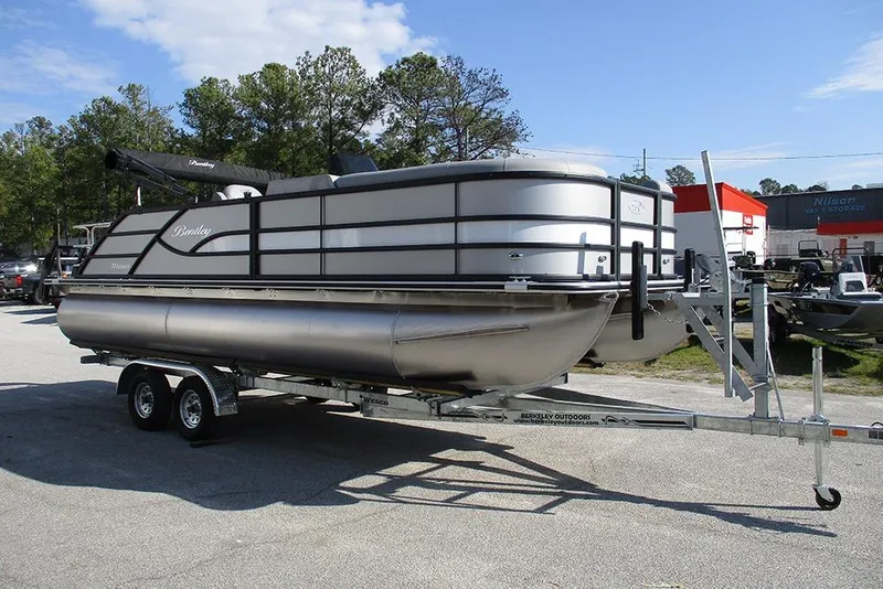 Slide: The Image of 2026 Bentley Pontoons Legacy 220 Swingback on trailer, parked outdoors. - 5