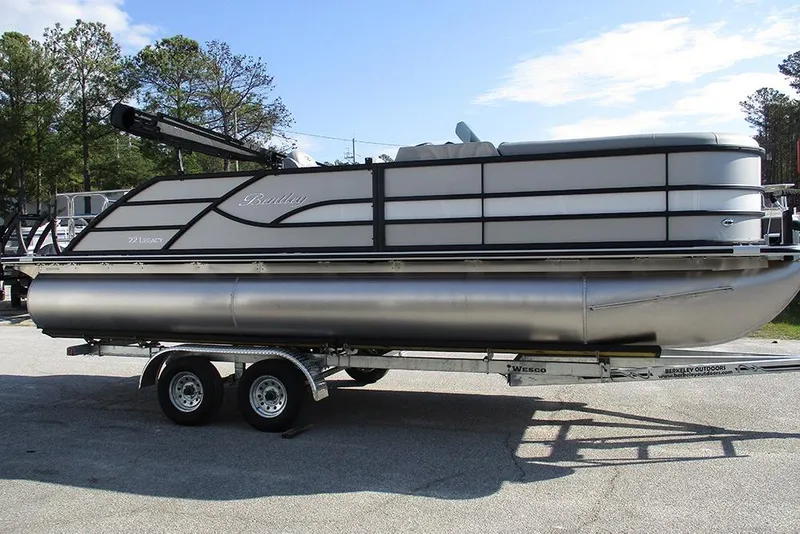 Slide: The Image of 2026 Bentley Pontoons Legacy 220 Swingback on trailer, parked outdoors. - 6