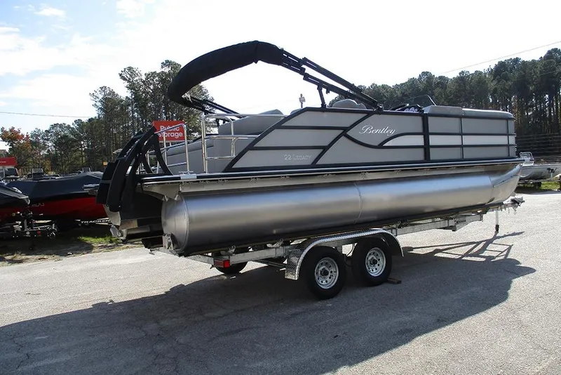 Slide: The Image of 2026 Bentley Pontoons Legacy 220 Swingback on trailer, parked outdoors. - 7