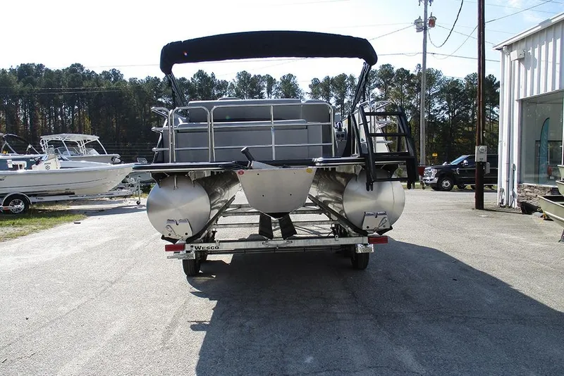 Slide: The Image of 2026 Bentley Pontoons Legacy 220 Swingback on trailer, parked outdoors. - 8
