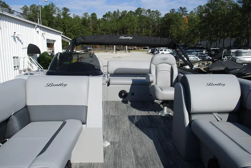 Slide: The Image of 2026 Bentley Pontoons Legacy 220 Swingback interior with gray seating and canopy. - 9