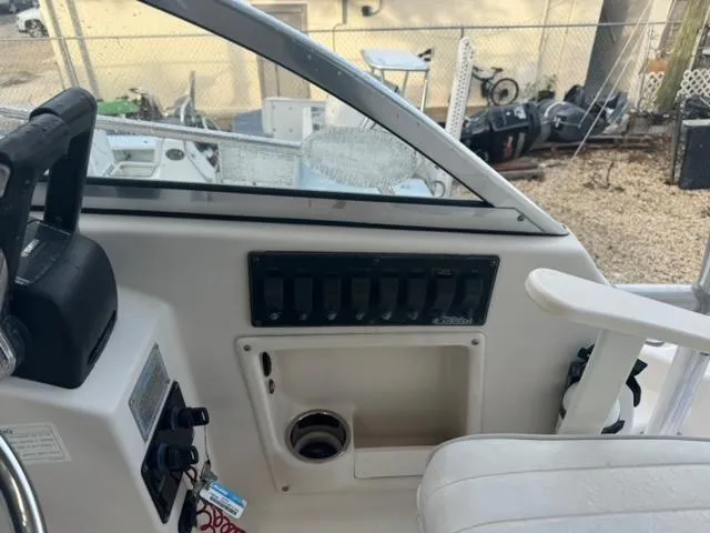 Slide: The Image of 2007 Cobia 270 boat cockpit with control panel and seating. - 10