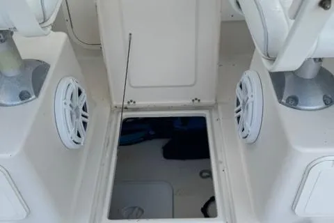 Slide: The Image of 2007 Cobia 270 boat interior with open hatch and speaker system. - 13