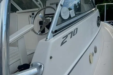 Slide: The Image of 2007 Cobia 270 boat interior with steering wheel and dashboard. - 15