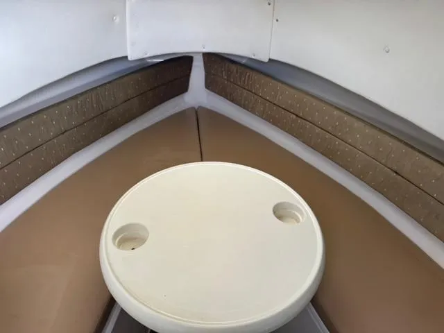 Slide: The Image of 2007 Cobia 270 boat interior with round table and cushioned seating. - 18