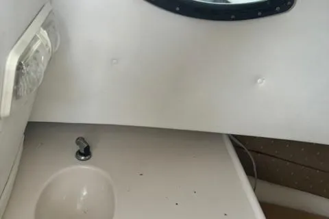 Slide: The Image of 2007 Cobia 270 boat deck with storage hatch and seating area. - 19