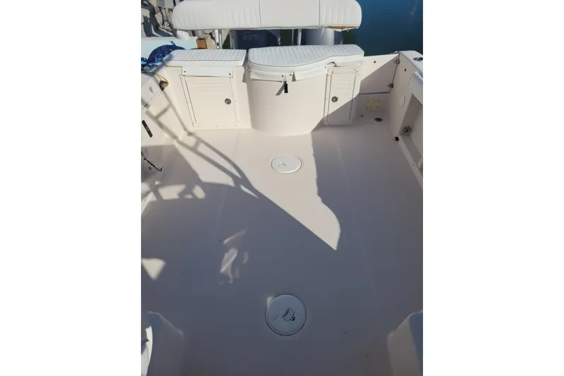 Slide: The Image of 2007 Cobia 270 boat deck with seating and storage compartments. - 21