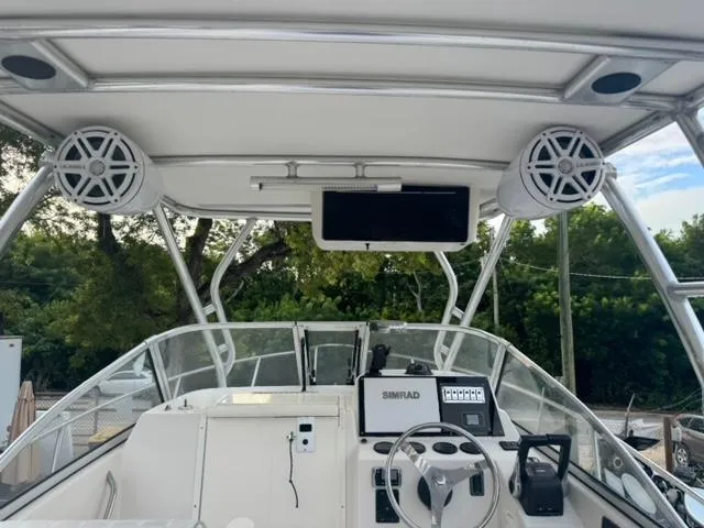 Slide: The Image of 2007 Cobia 270 boat dashboard with electronics, speakers, and steering wheel. - 7