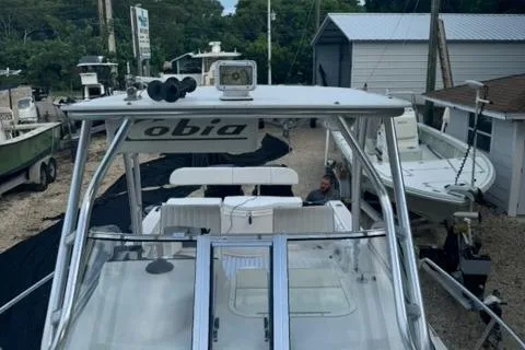 Slide: The Image of 2007 Cobia 270 boat with white seating, docked at a marina. - 8