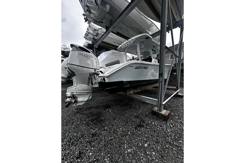 Slide: The Image of 2023 Sea Pro 320 DLX Offshore boat with Suzuki outboard engine in storage. - 14