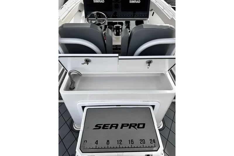 Slide: The Image of 2023 Sea Pro 320 DLX Offshore boat interior with Simrad electronics and branded measuring board. - 3