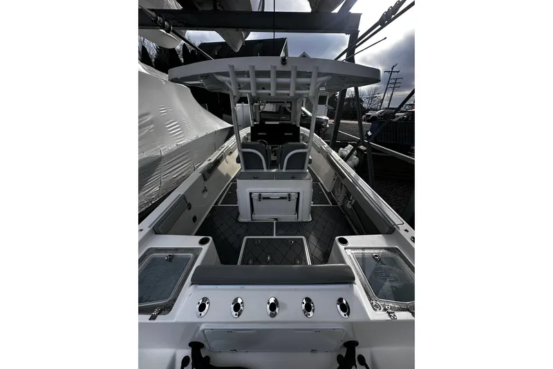 Slide: The Image of 2023 Sea Pro 320 DLX Offshore boat interior with seating and storage compartments. - 4