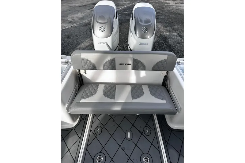 Slide: The Image of 2023 Sea Pro 320 DLX Offshore boat with dual Suzuki 350 engines and cushioned seating. - 5