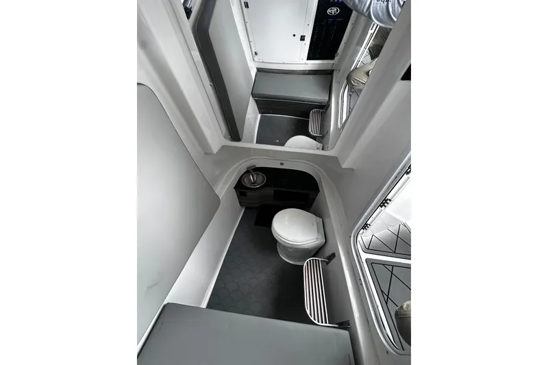 Slide: The Image of 2023 Sea Pro 320 DLX Offshore boat interior with compact bathroom amenities. - 6