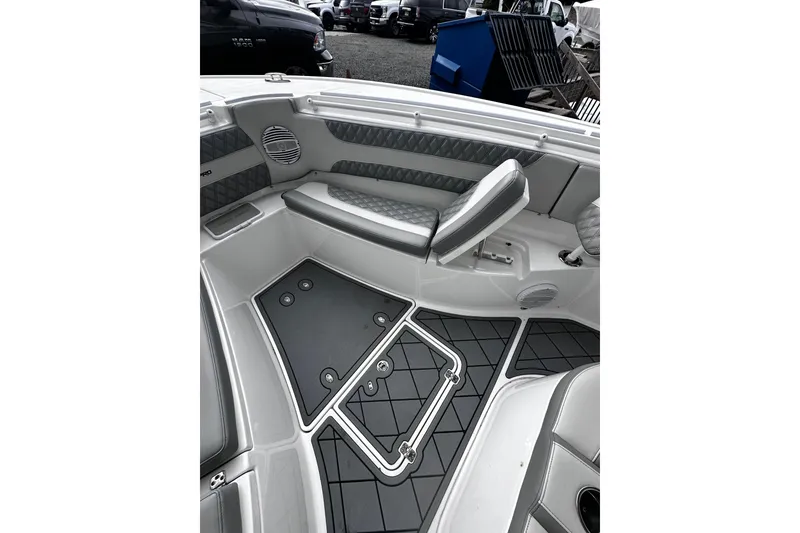 Slide: The Image of 2023 Sea Pro 320 DLX Offshore boat interior with cushioned seating and storage compartments. - 8