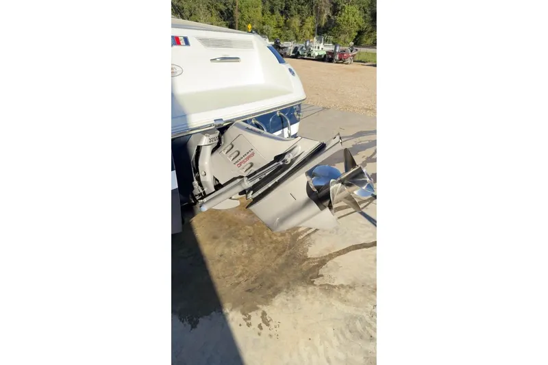 Slide: The Image of 1998 Cobalt 220 boat with stainless steel propeller in a sunny outdoor setting. - 11