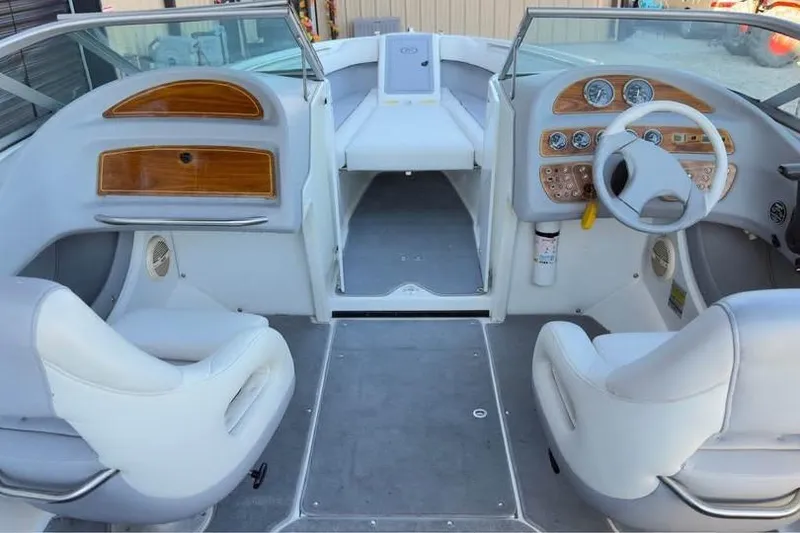 Slide: The Image of Interior of a 1998 Cobalt 220 boat with white seating and wooden dashboard accents. - 2