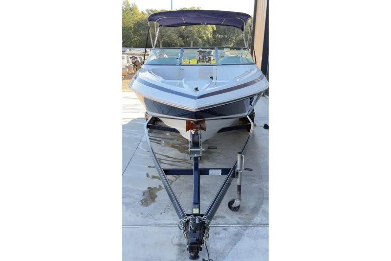 Slide: The Image of 1998 Cobalt 220 boat on trailer with canopy, parked outdoors. - 9