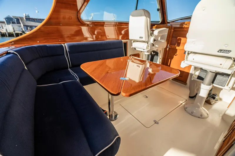 Slide: The Image of Interior of 2007 Hinckley Picnic Boat 36 EP with elegant seating and wooden table. - 11
