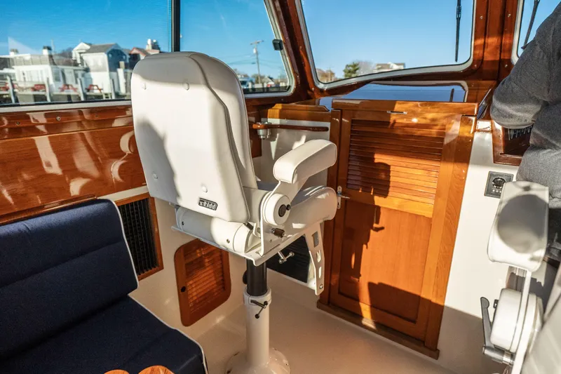 Slide: The Image of Interior of 2007 Hinckley Picnic Boat 36 EP with elegant wood finish and seating. - 13