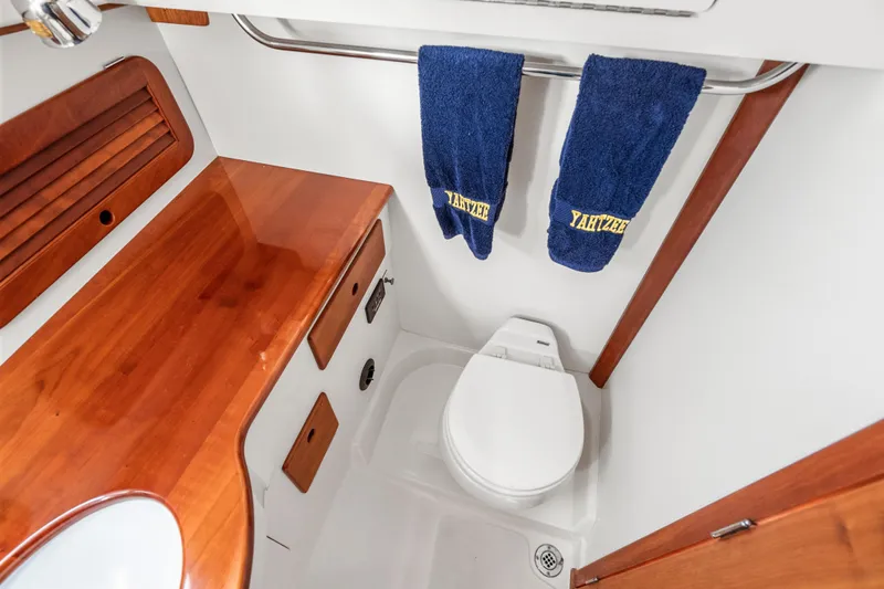 Slide: The Image of 2007 Hinckley Picnic Boat 36 EP bathroom with wooden cabinetry and blue towels. - 21