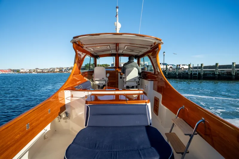 Slide: The Image of 2007 Hinckley Picnic Boat 36 EP cruising on calm waters, showcasing elegant wooden interior. - 8