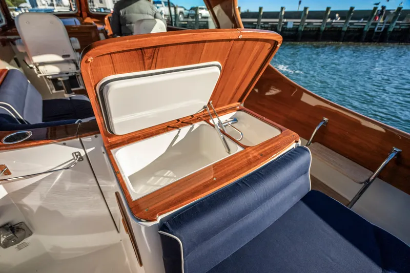 Slide: The Image of 2007 Hinckley Picnic Boat 36 EP interior with open storage compartment by the water. - 9