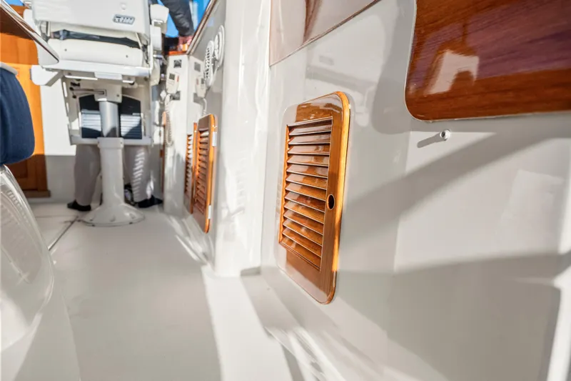 Slide: The Image of 2007 Hinckley Picnic Boat 36 EP interior with wooden accents and seating area. - 10