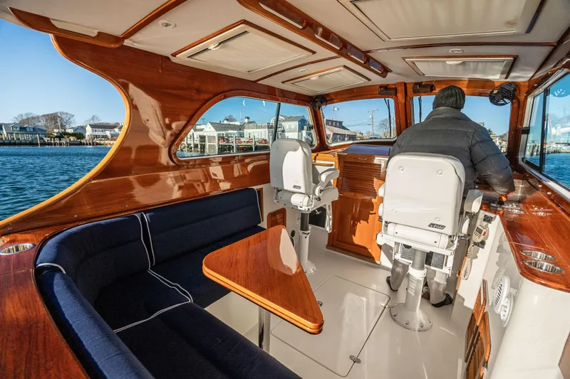 Slide: The Image of Interior of 2007 Hinckley Picnic Boat 36 EP with elegant wood finish and seating. - 12