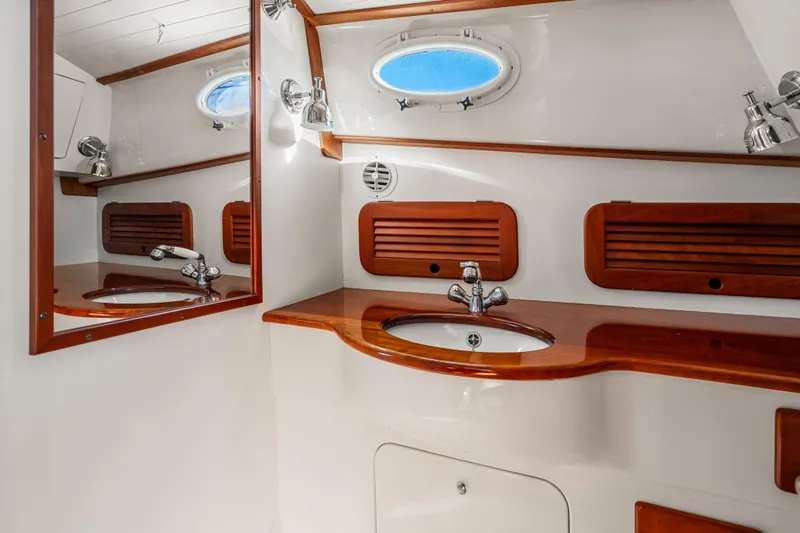 Slide: The Image of Luxurious 2007 Hinckley Picnic Boat 36 EP bathroom with elegant wood accents and modern fixtures. - 20